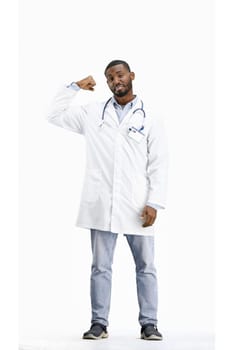 The doctor, in full height, on a white background, shows strength.