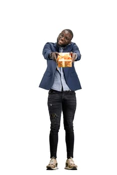 A man, full-length, on a white background, with a gift.