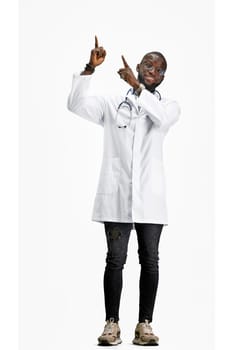 The doctor, in full height, on a white background, points up.