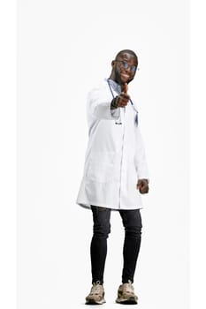 The doctor, in full height, on a white background, shows a thumbs up.