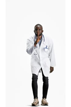 The doctor, in full height, on a white background, shows a sign of silence.