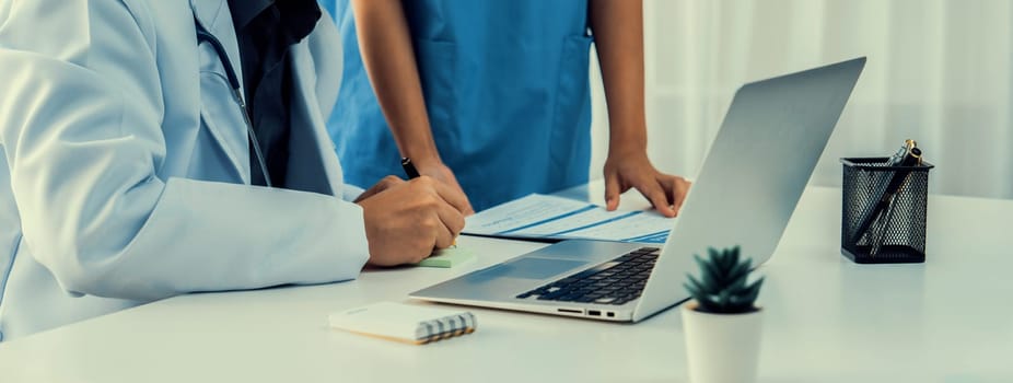 Professional various team of medical working and planning medical treatment at hospital table together. Teamwork lead to successful illness and sickness treatment. Panorama Rigid