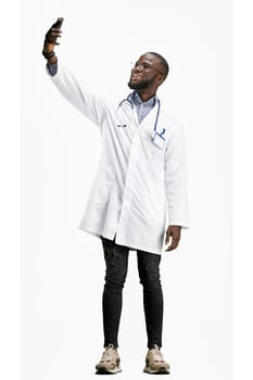 The doctor, in full height, on a white background, talking on the phone.