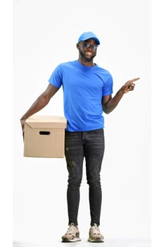 The deliveryman, in full height, on a white background, points to the side.