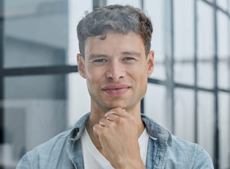 Portrait of smiling businessman standing at corporate office