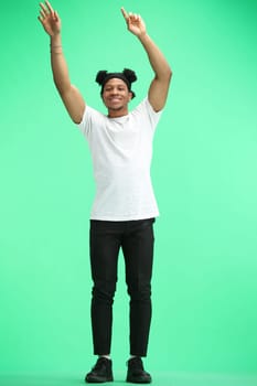 A man, full-length, on a green background, waving his arms.