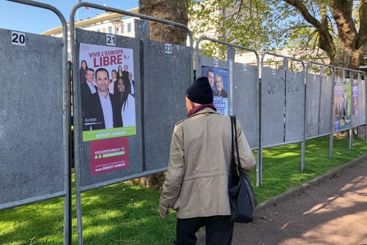 DIEPPE, FRANCE - MAY 15, 2019 : Man looks at the banner with candidates for elections to the European Union in May 2019