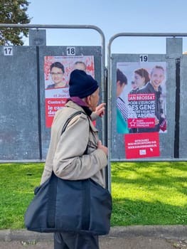 DIEPPE, FRANCE - MAY 15, 2019 : Man looks at the banner with candidates for elections to the European Union in May 2019