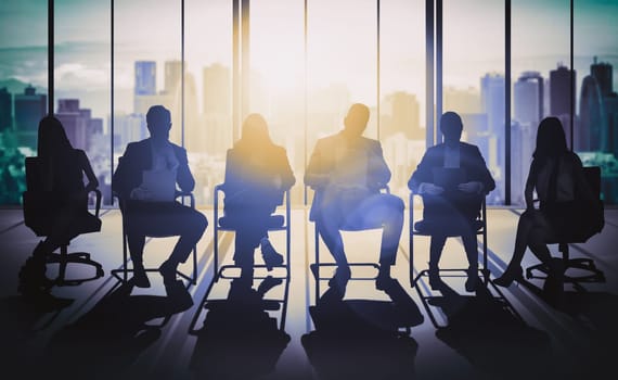 Double exposure image of many business people conference group meeting on city office building in background showing partnership success of business deal. Concept of teamwork, trust and agreement. uds