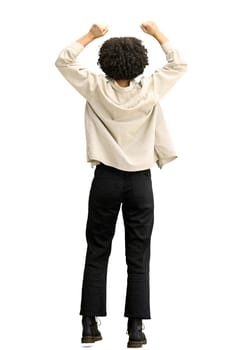 A woman, full-length, on a white background, raised her hands up.