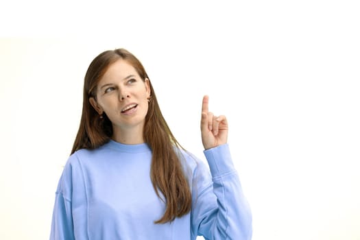 Woman, close-up, on a white background, pointing up.