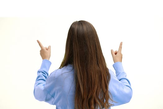 Woman, close-up, on a white background, pointing up.