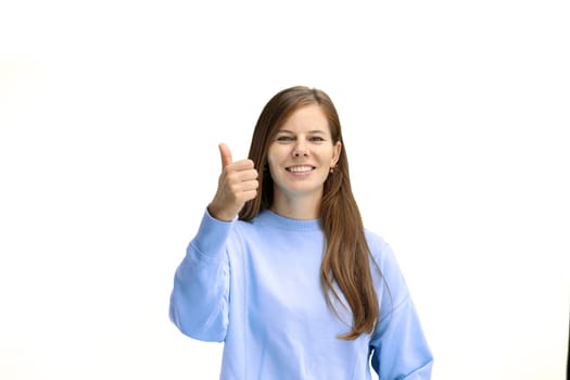 A woman, close-up, on a white background, shows her thumbs up.