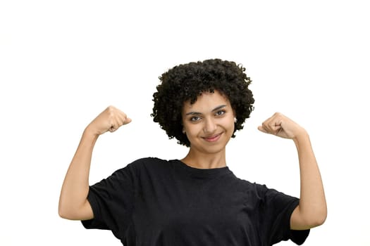 A woman, close-up, on a white background, shows strength.