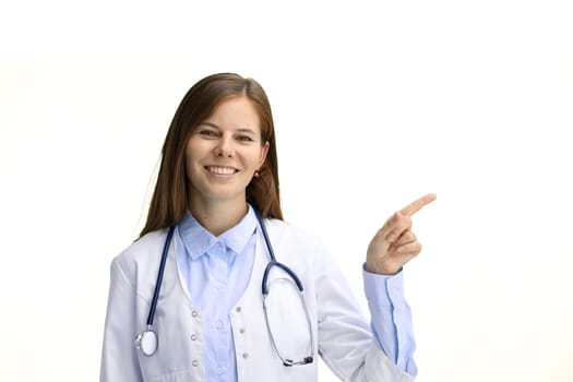 Female doctor, close-up, on a white background, pointing to the side.