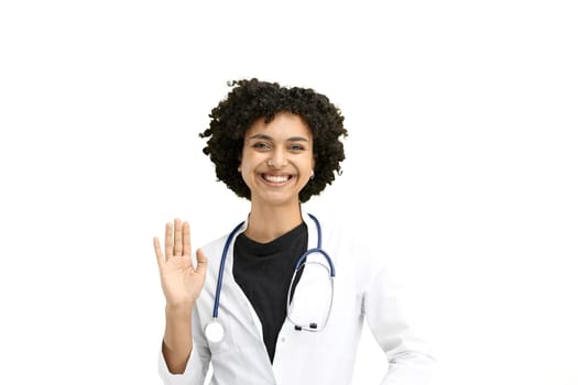 Female doctor, close-up, on a white background, waving her hand.