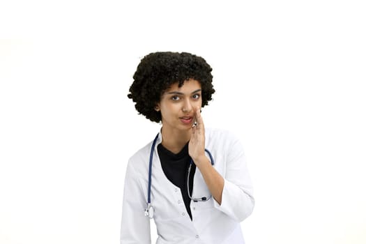 Female doctor, close-up, on a white background, tells a secret.