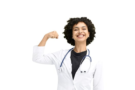 Female doctor, close-up, on a white background, shows strength.