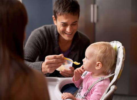 Happy, baby and dad in feeding at home in the morning with nutrition and wellness. Father, family and food of a infant with development and breakfast in a house kitchen with love, support and care.