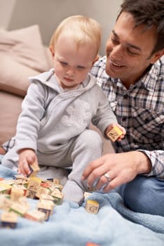 Happy father, baby and playing with blocks in home with love, pride and learning shapes or color in living room. Dad, daughter and educational toy for creativity and development of fine motor skills.