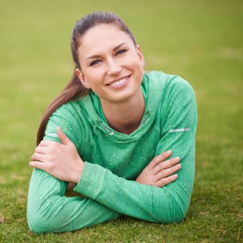 Smile, sports and portrait of woman on grass for fitness, exercise and workout for wellness. Athlete, happy and face of female person in nature for training, health and laying in park outdoors.