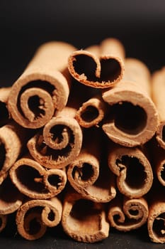 cinnamon sticks closeup on a black background.