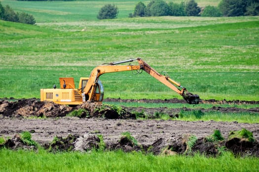Excavator operation on a green field