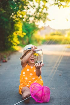 A child catches a butterfly in nature. selective focus. kid.