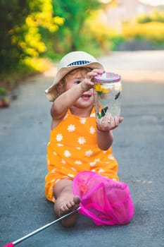 A child catches a butterfly in nature. selective focus. kid.