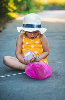 A child catches a butterfly in nature. selective focus. kid.