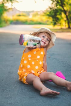 A child catches a butterfly in nature. selective focus. kid.