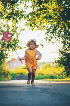 A child catches a butterfly in nature. selective focus. kid.