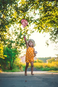 A child catches a butterfly in nature. selective focus. kid.