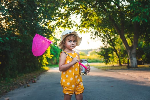 A child catches a butterfly in nature. selective focus. kid.