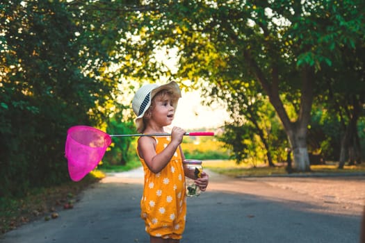 A child catches a butterfly in nature. selective focus. kid.