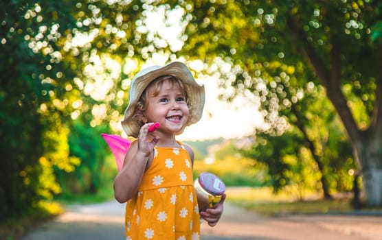 A child catches a butterfly in nature. selective focus. kid.