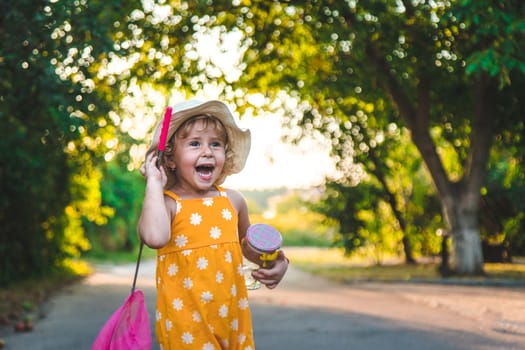 A child catches a butterfly in nature. selective focus. kid.