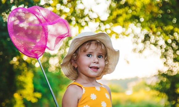 A child catches a butterfly in nature. selective focus. kid.