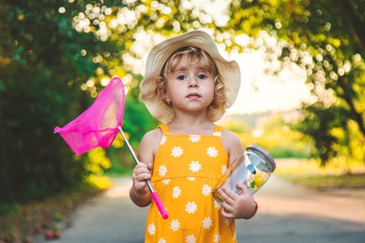 A child catches a butterfly in nature. selective focus. kid.