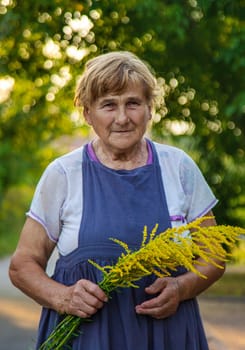 An elderly woman is allergic to ragweed. selective focus. Nature.