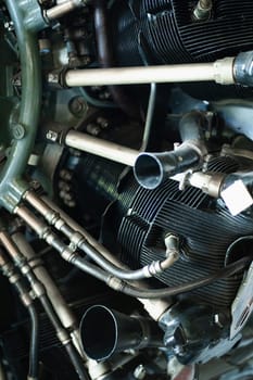 Old airplane engine, closeup metal pipes and details of small gasoline plane