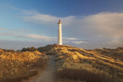 Lighthouse at sunset in a coastal city Hvide Sande Denmark.