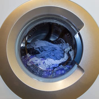 a close view of domestic washing machine at work.