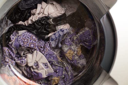 a close view of domestic washing machine at work.