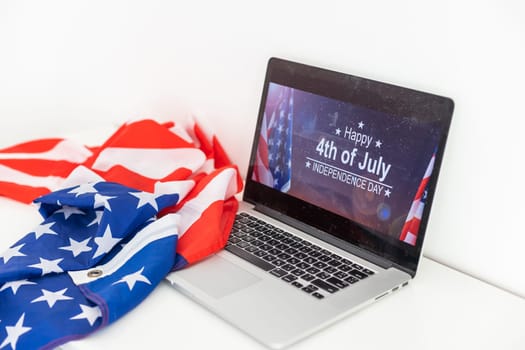 laptop with inscription 4 July inscription over american flag. Independence day. High quality photo