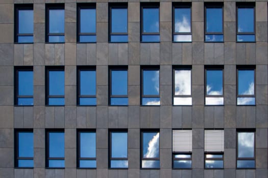 reflection of the sky in the windows of an office building. High quality photo