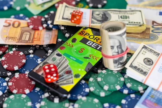 Creative background, online casino, in a man's hand a smartphone with playing cards, roulette and chips, black-gold background. Internet gambling concept. Copy space. High quality photo