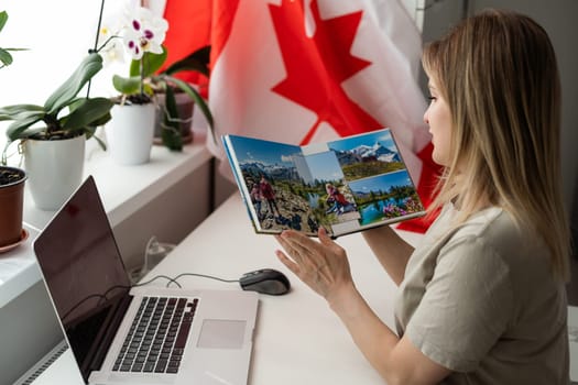 beautiful smiling woman covered in canadian flag looking at camera isolated on white. High quality photo