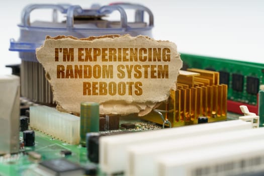 On the computer motherboard there is a cardboard with the inscription - I'm experiencing random system reboots. Computer repair concept.