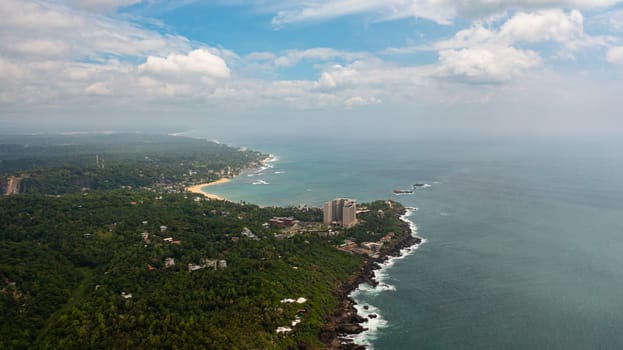 Aerial view of coastline with beaches and hotels. Unawatuna, Sri Lanka.